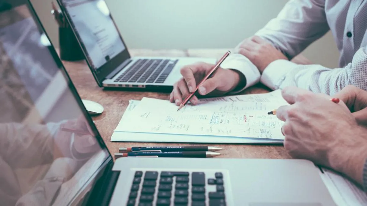 Hiring manager signing a staffing agreement, contract vs direct hire guide by Dworo.io